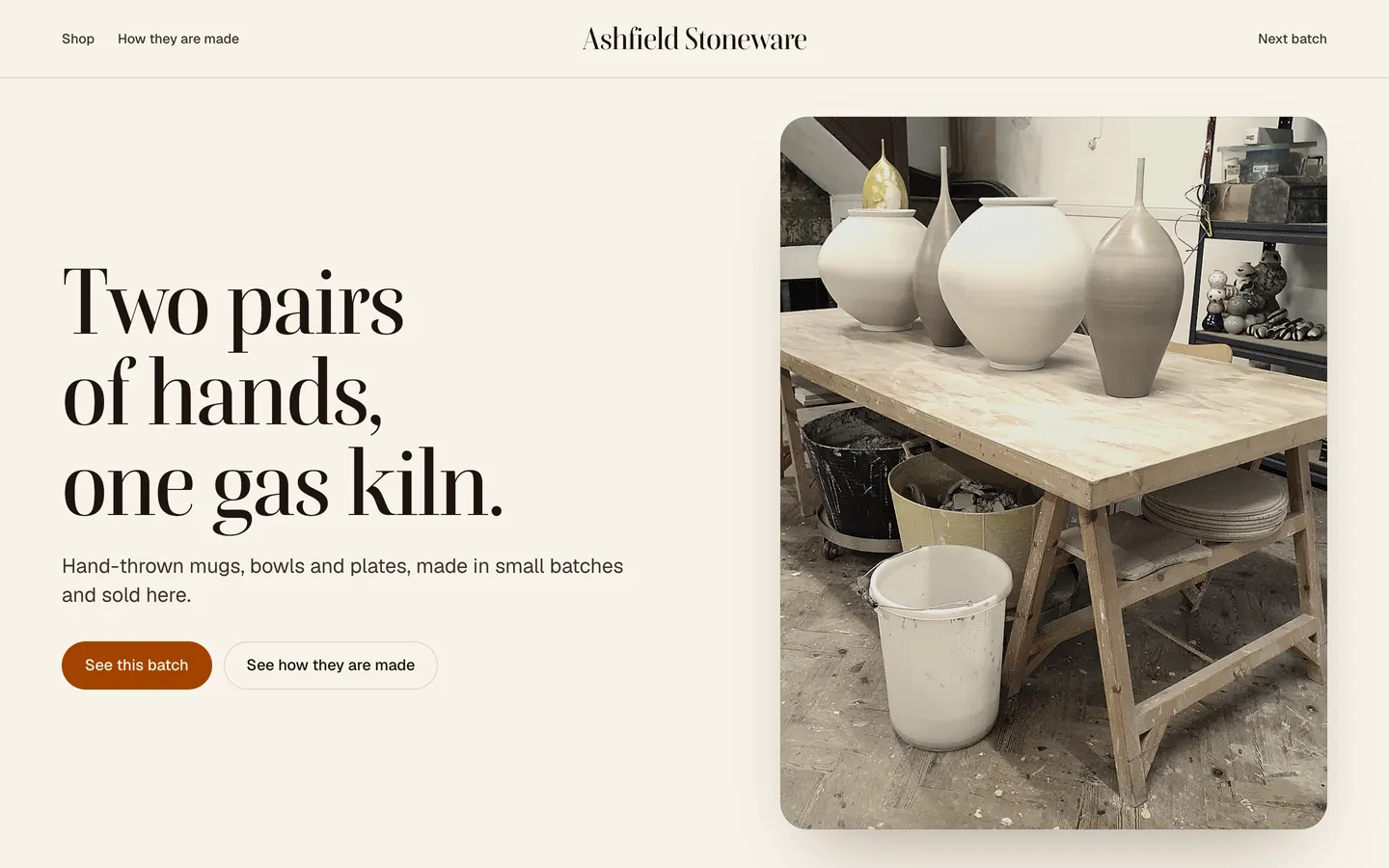 Ashfield Stoneware: tall pale vases on a workshop table beside the headline Two pairs of hands, one gas kiln.