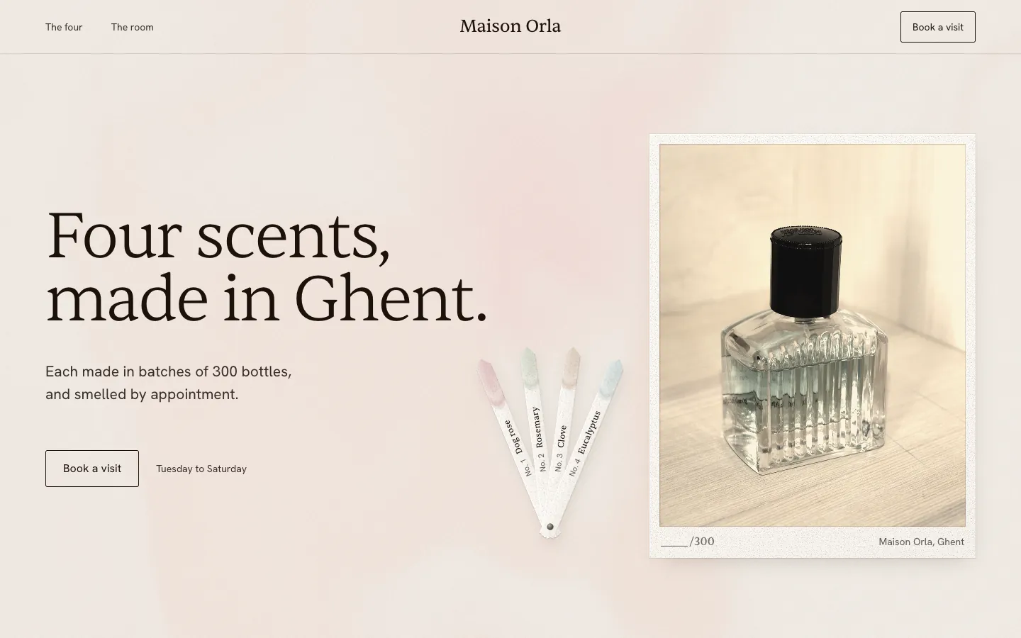 Maison Orla: four perfumer's blotters fanned beside a framed photograph of a glass bottle under the headline Four scents, made in Ghent.